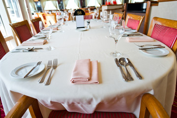 fork and knife on a napkin with plate.