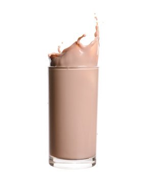 Splash of chocolate milk from the glass on isolated white background.