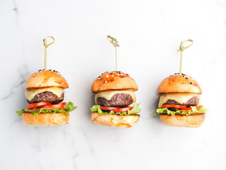 Tasty burger and cheeseburger on a marble table