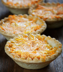 still life of tartlets with cheese and carrots