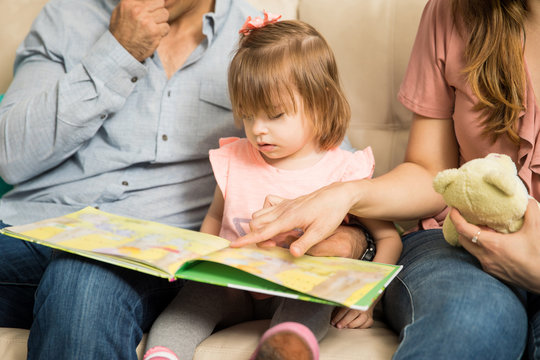 Young Family Reading A Book Together