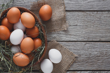 Fresh chicken brown eggs on sack, organic farming background