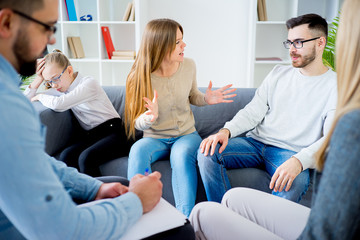 Couple arguing at therapy session in therapists office