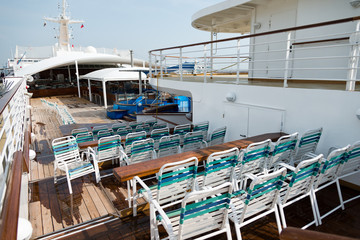 row of sun chairs  on the ship deck