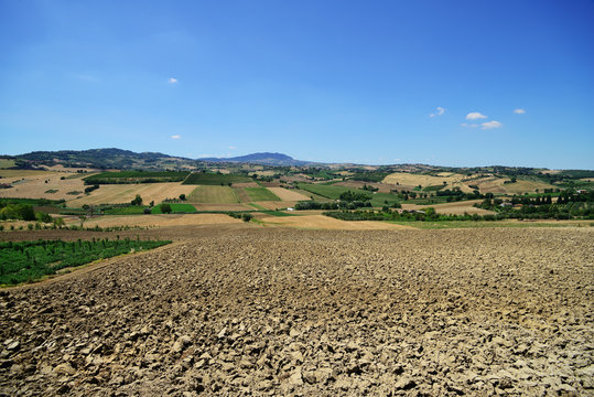Countryside in Coriano, plowed field (near Rimini), Emilia-Romagna, Italy. Far viev to Monte Titano and San Marino.