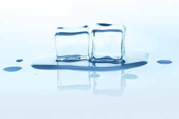Melting ice cubes with reflection isolated on white.