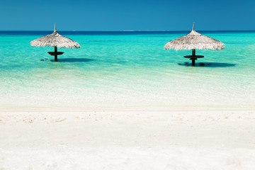 Straw parasol on water at tropical island