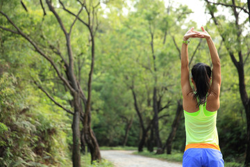 young woman trail runner warm up outdoor