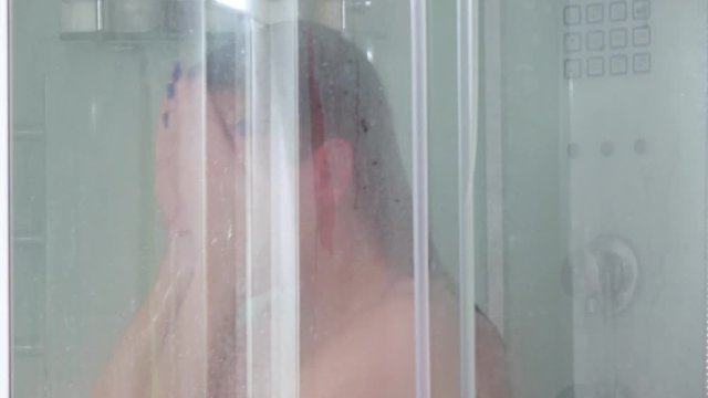 Girl washes her head in shower