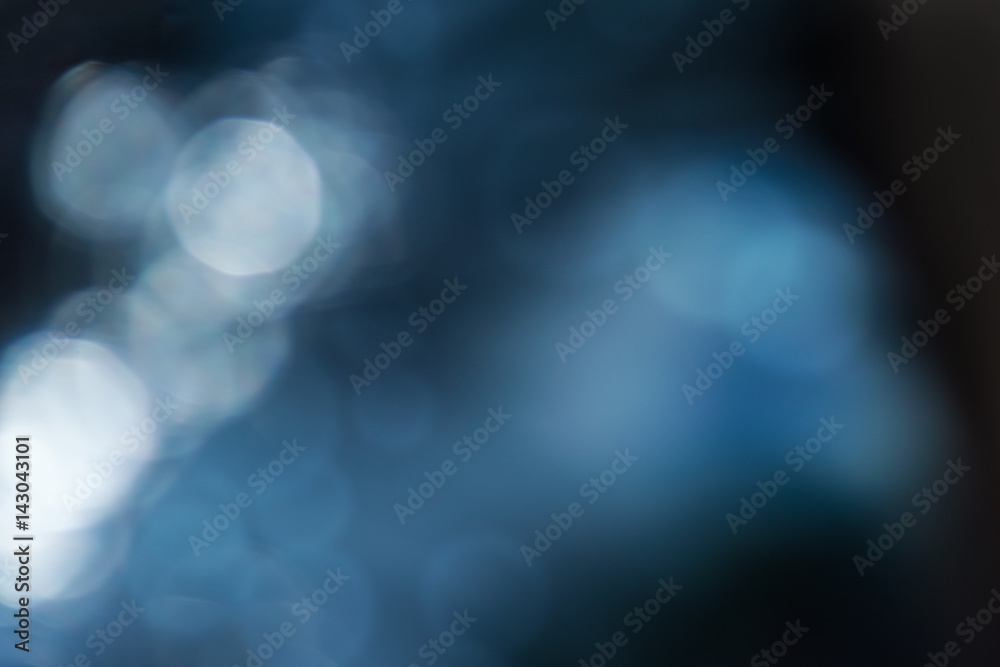Wall mural blurred abstract background in dark blue tones with bokeh effect