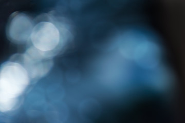 blurred abstract background in dark blue tones with bokeh effect