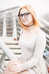 Girl with red hair against the backdrop of the morning city