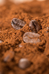 Mixology in action. Close up shot of roasted coffee beans mixed with grounded coffee.