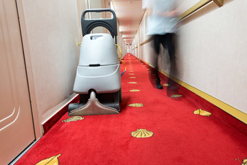 vacuum cleaner stands in the hotel corridor.