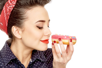 Beautiful pinup woman enjoying donuts