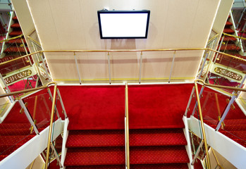 Red carpet on a stairway in a luxury cruise.
