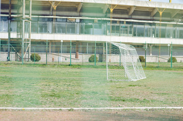 Fototapeta premium Football Field With Green Grass Shot Through Wire Net
