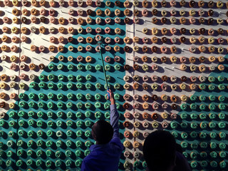Man reaching up to pick doughnut off wall