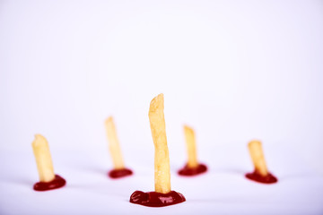 Fries standing in ketchup. Team or Leadership concept