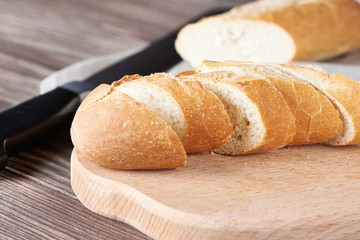 Sliced bread on the wooden plank