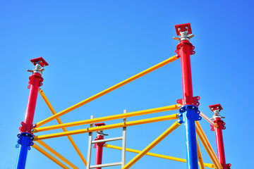 Colorful new scaffolding against bright blue sky