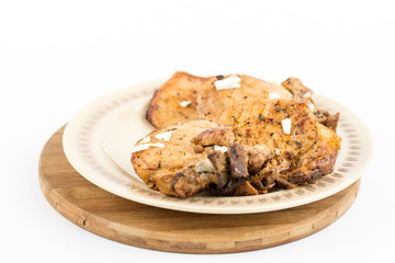 Fried pork chops served on the plate isolated over white background
