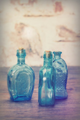 Coloured glass bottles on a rustic background