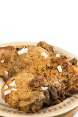 Fried pork chops served on the plate isolated over white background