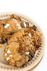 Fried pork chops served on the plate isolated over white background