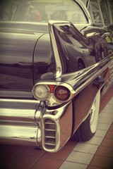 Close up shot of a vintage car in sepia color tone