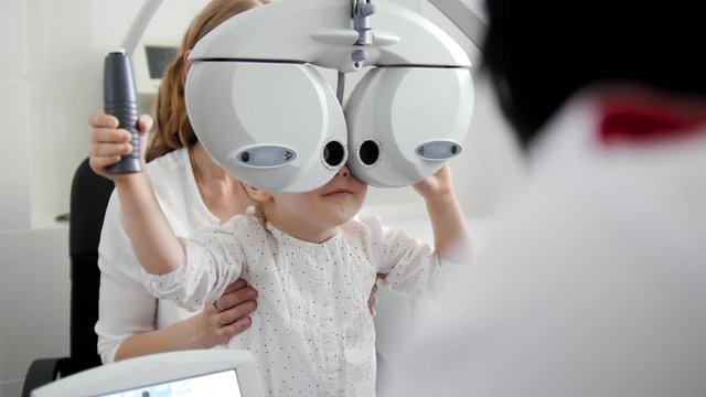 Children ophthalmology - telephoti view - optometrist Checks Eye of little girl