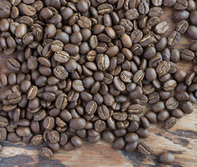 Roasted coffee beans on grunge wood background