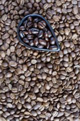 Roasted coffee beans of three different level in black bow on grunge wooden background