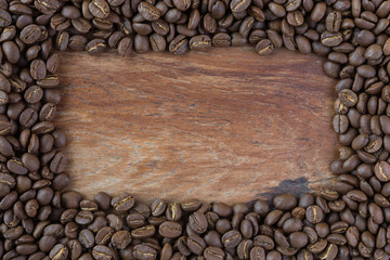 Roasted coffee beans on grunge wood background