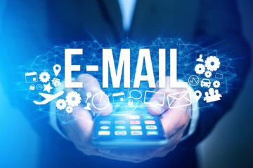 Concept of man holding futuristic interface with e-mail title and multimedia icons flying all around - Internet concept