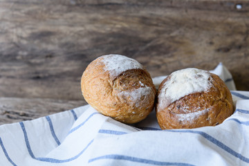 Whole wheat bread set in bamboo basket on wooden table top background