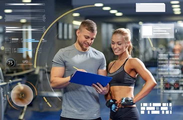 Türaufkleber smiling young woman with personal trainer in gym © Syda Productions
