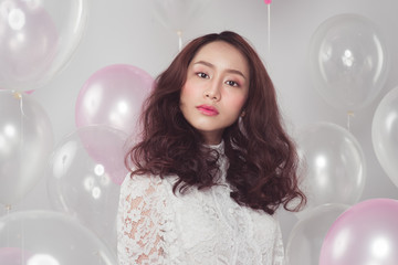Stylish fashion asian woman with pastel balloons