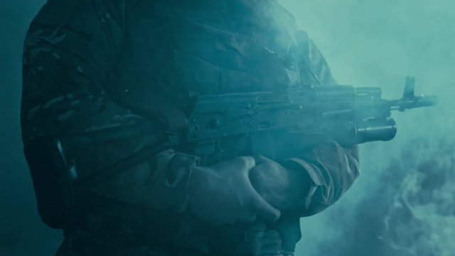 Soldier standing with kalashnikov. Standing silhouette soldier rifle. Close up of soldier hold kalashnikov rifle. Soldier holding machine gun ak 47