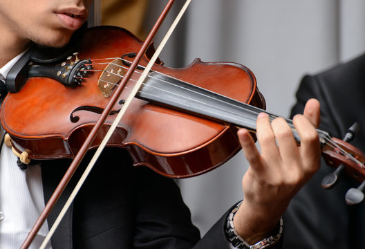 Violinist Playing a Symphony