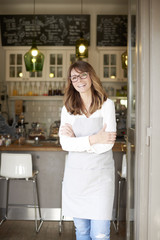 Proud small coffee shop owner businesswoman. Shot of  a happy barista woman standing at doorway and...