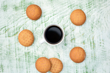 Obraz na płótnie Canvas biscuits and cup of coffee on wooden background 
