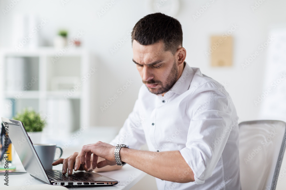 Poster businessman with laptop and wristwatch at office