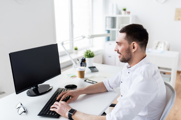 businessman typing on computer keyboard at office