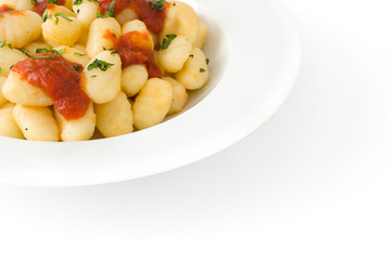 Gnocchi with tomato sauce isolated on white background.
