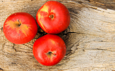 Red apples on wooden background