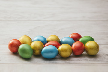 Colorful Easter holiday eggs mother of pearl on wooden table