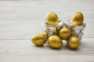 Golden Easter eggs with stands of silver foil