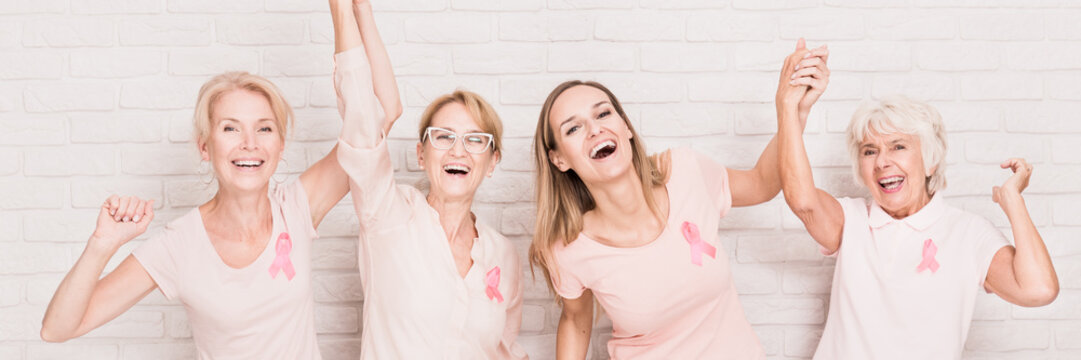 Laughing women with breast cancer ribbons