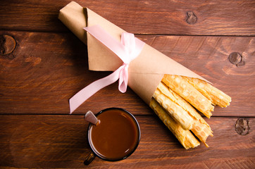 tubular wafer. waffles on wooden boards. hot chocolate. Kraft paper
